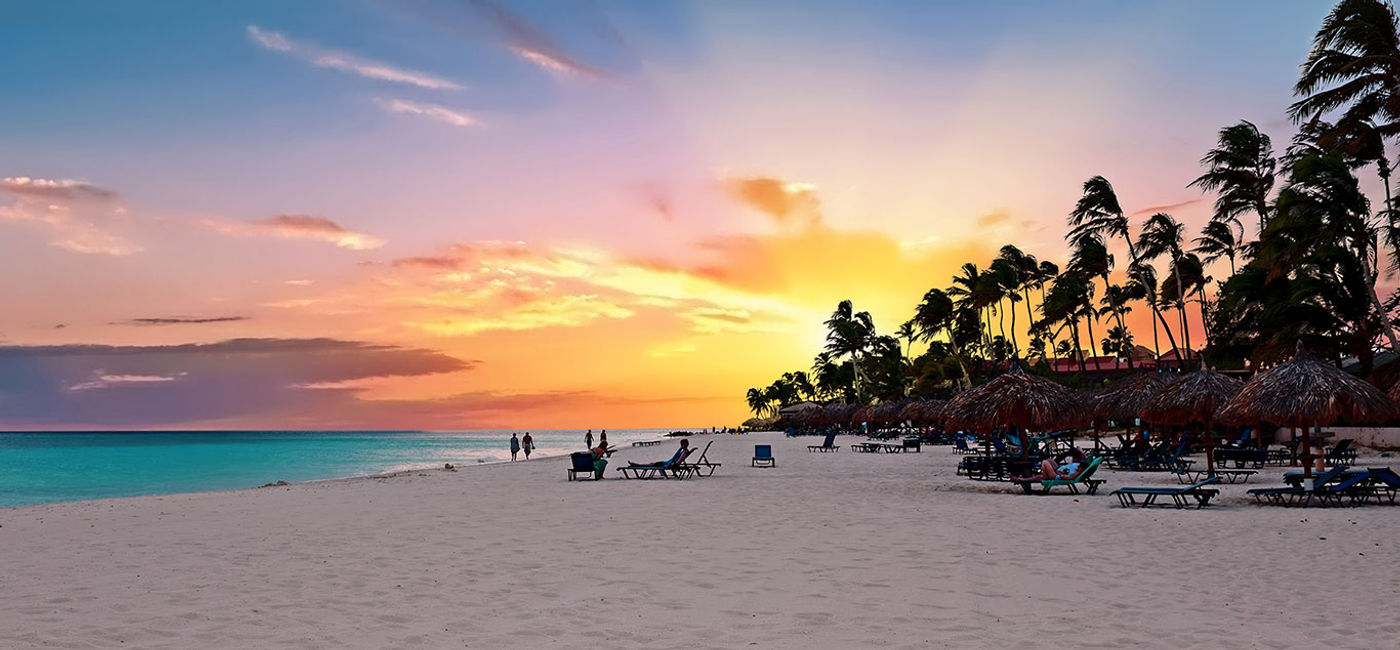 Image: Druif beach at sunset on Aruba in the Caribbean Sea. (Photo Credit: Nisangha / iStock / Getty Images Plus)